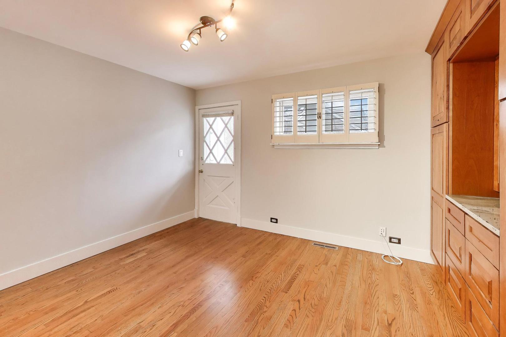7 Alton Road Prospect Heights, IL 60070 - Photo 14 of 44 wooden floor in an empty room with a window