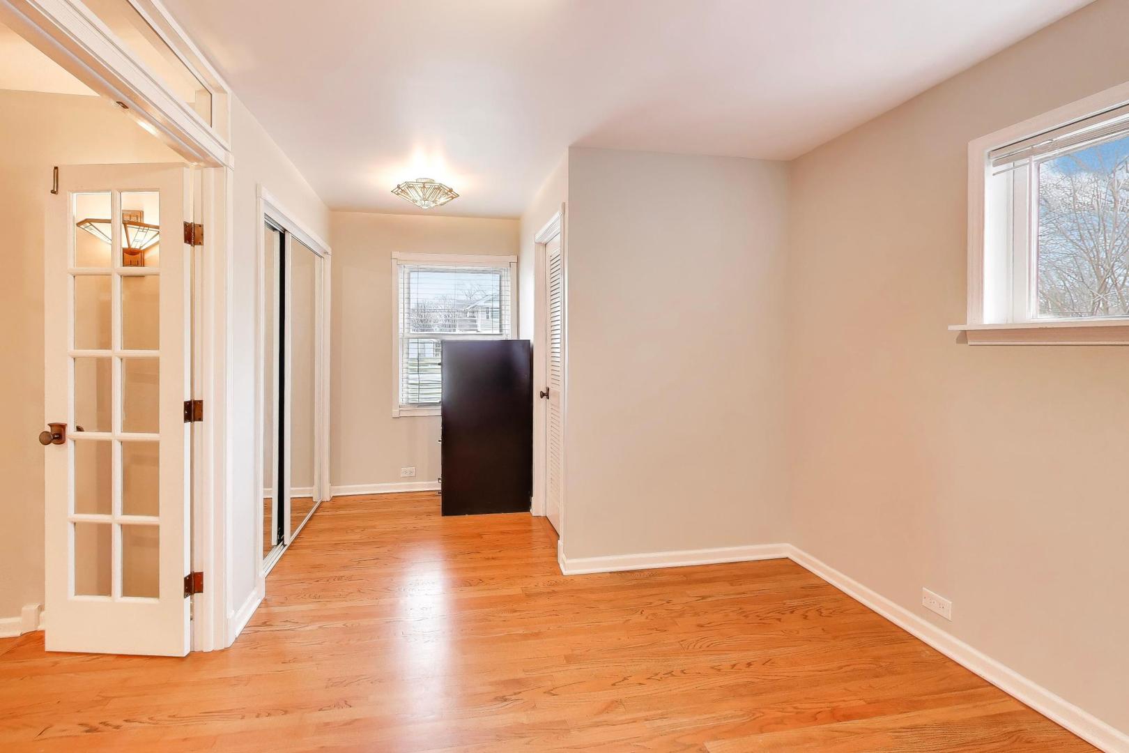 7 Alton Road Prospect Heights, IL 60070 - Photo 17 of 44 a view of a hallway with wooden floor and a living room