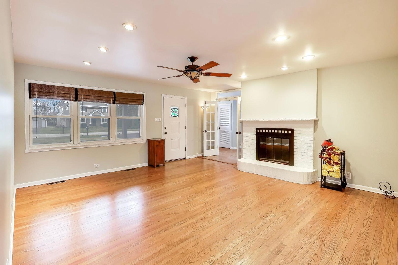 7 Alton Road Prospect Heights, IL 60070 - Photo 5 of 44 an empty room with fireplace wooden floor and windows