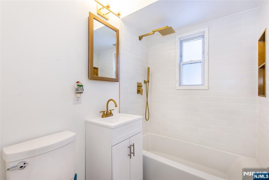 116 Edison Street Clifton, NJ 07013 - Photo 11 of 19 a bathroom with a sink a toilet and a bathtub