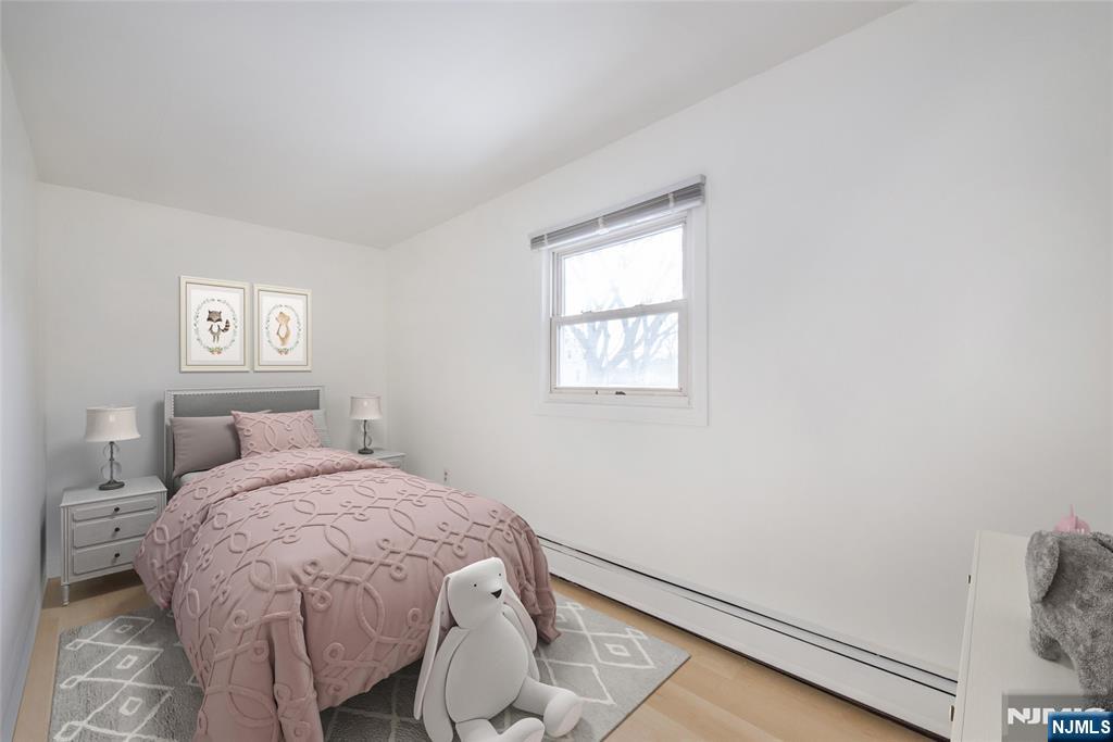 116 Edison Street Clifton, NJ 07013 - Photo 14 of 19 a bed sitting in a bedroom next to a window