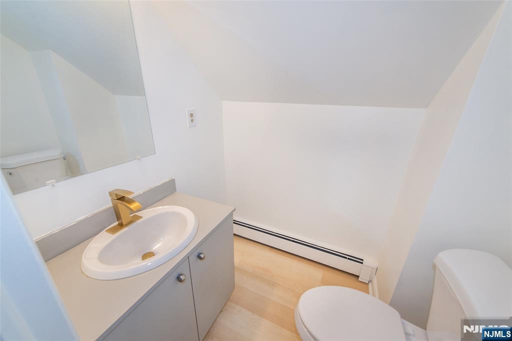 116 Edison Street Clifton, NJ 07013 - Photo 16 of 19 a bathroom with a sink a toilet and mirror