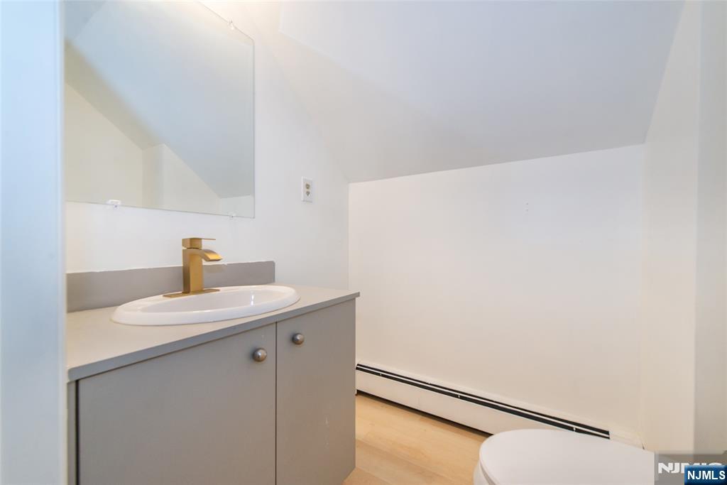 116 Edison Street Clifton, NJ 07013 - Photo 17 of 19 a bathroom with a sink and a mirror