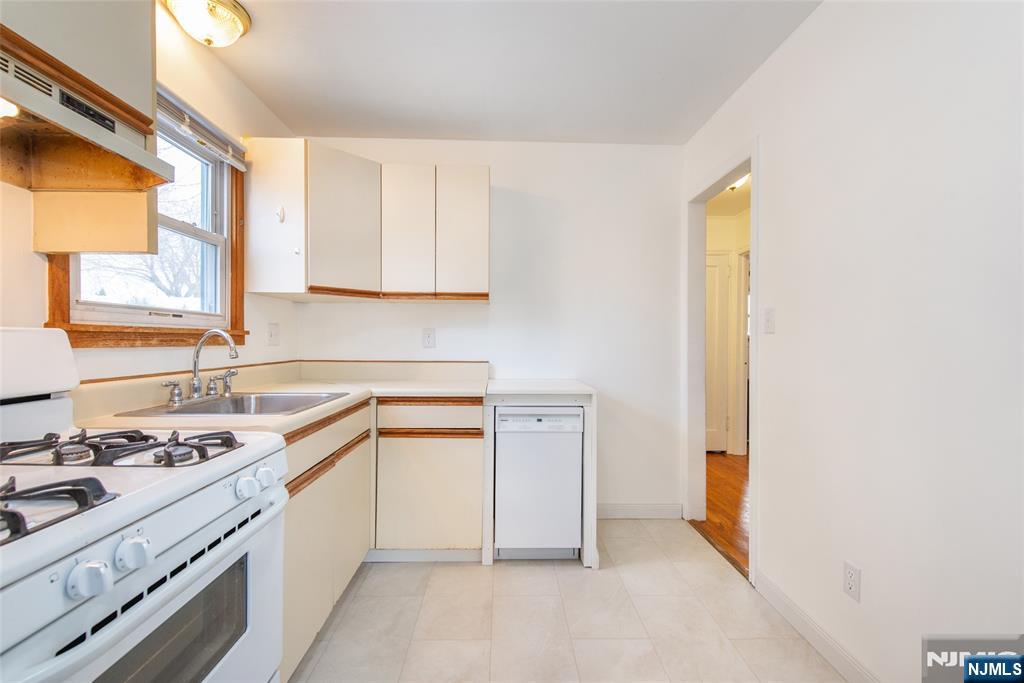 116 Edison Street Clifton, NJ 07013 - Photo 8 of 19 a kitchen with a sink stove and cabinets