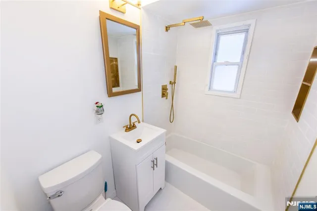 a bathroom with a sink a toilet and bathtub