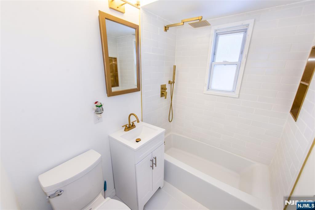116 Edison Street Clifton, NJ 07013 - Photo 10 of 19 a bathroom with a sink a toilet and bathtub