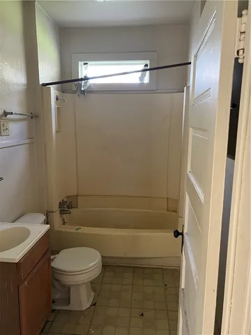 a bathroom with a toilet and shower