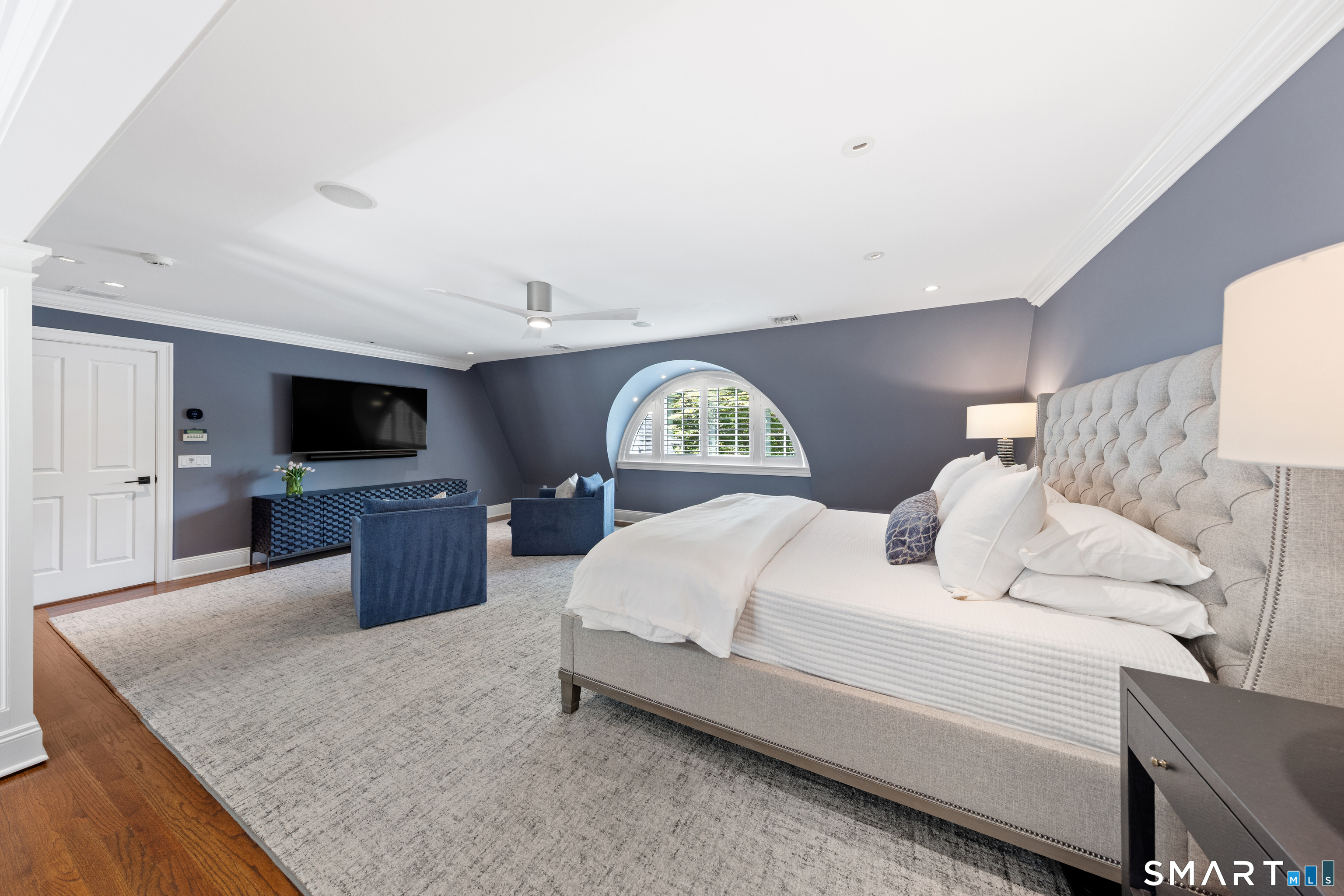99 Hickok Road New Canaan, CT 06840 - Photo 16 of 39 a spacious bedroom with a bed and a flat screen tv