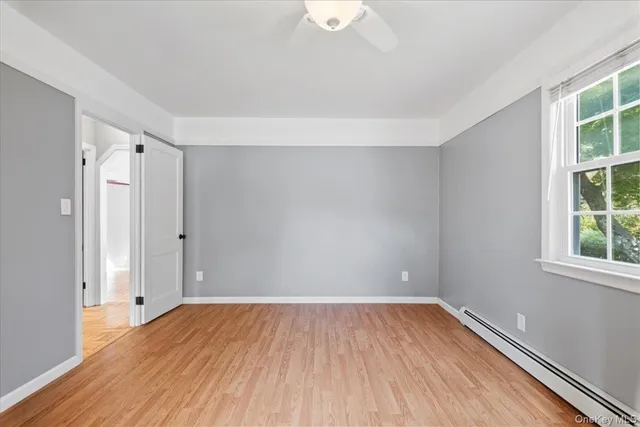 wooden floor in an empty room with a window