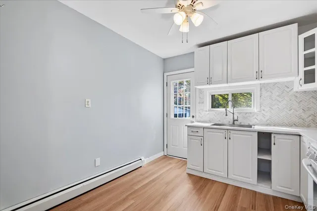 a kitchen with a sink cabinets and window