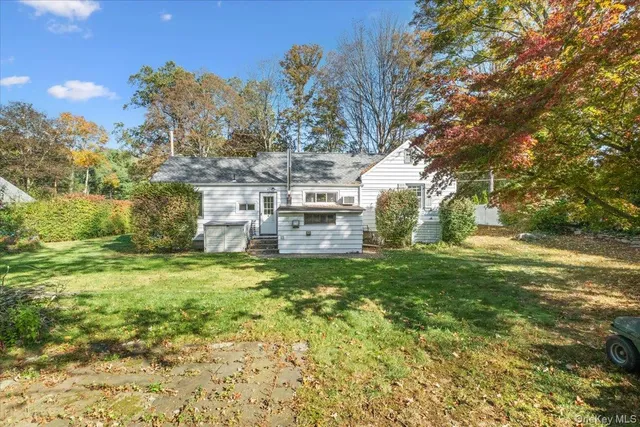 a yellow building in the middle of a yard