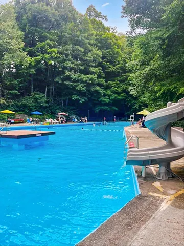swimming pool view with a seating space