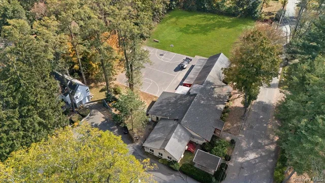 an aerial view of a house with a garden and lake view
