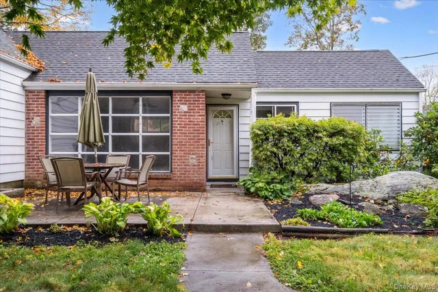 a front view of a house with garden and porch