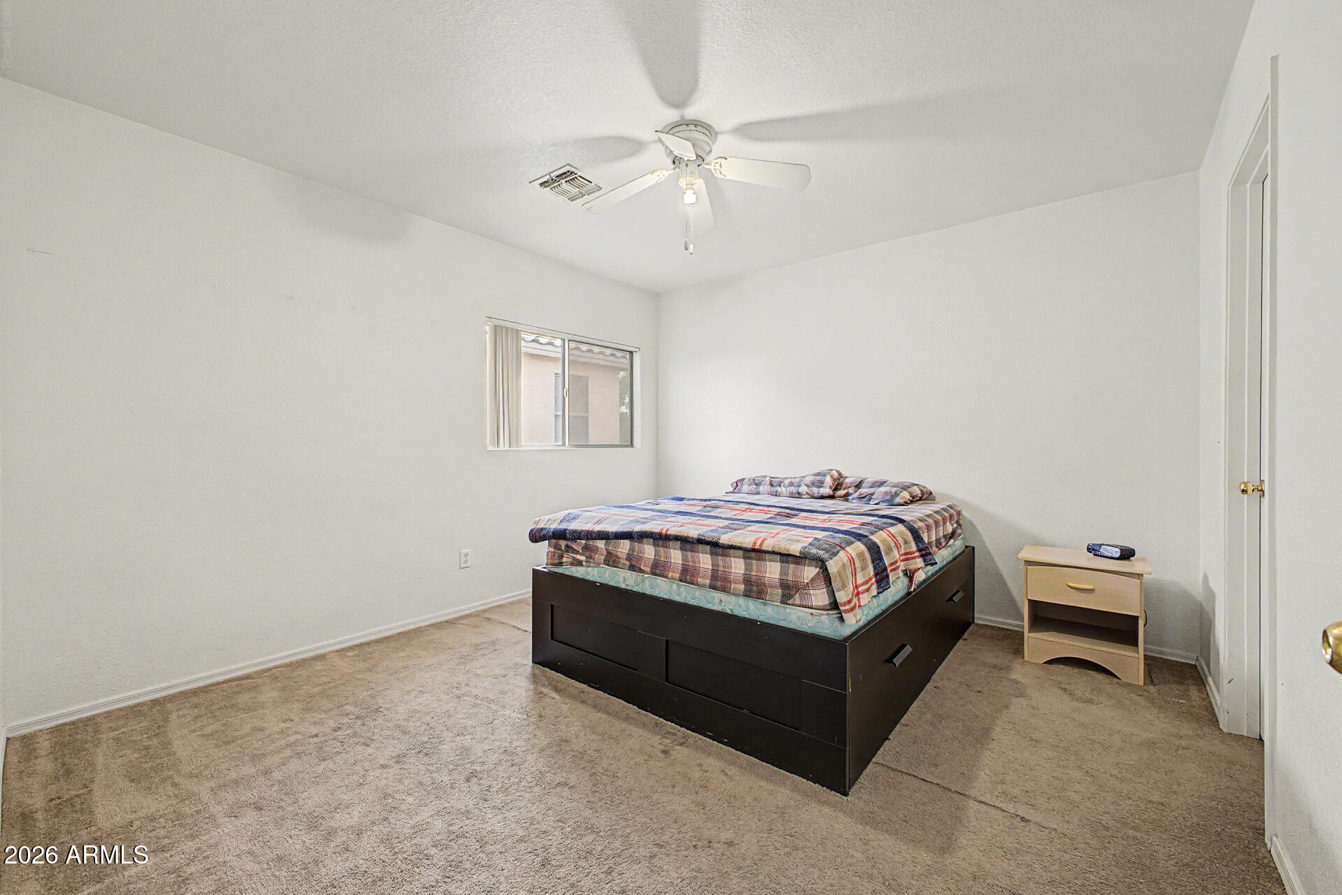2607 West Bloch Road Phoenix, AZ 85041 - Photo 22 of 34 a bedroom with a bed and a chandelier