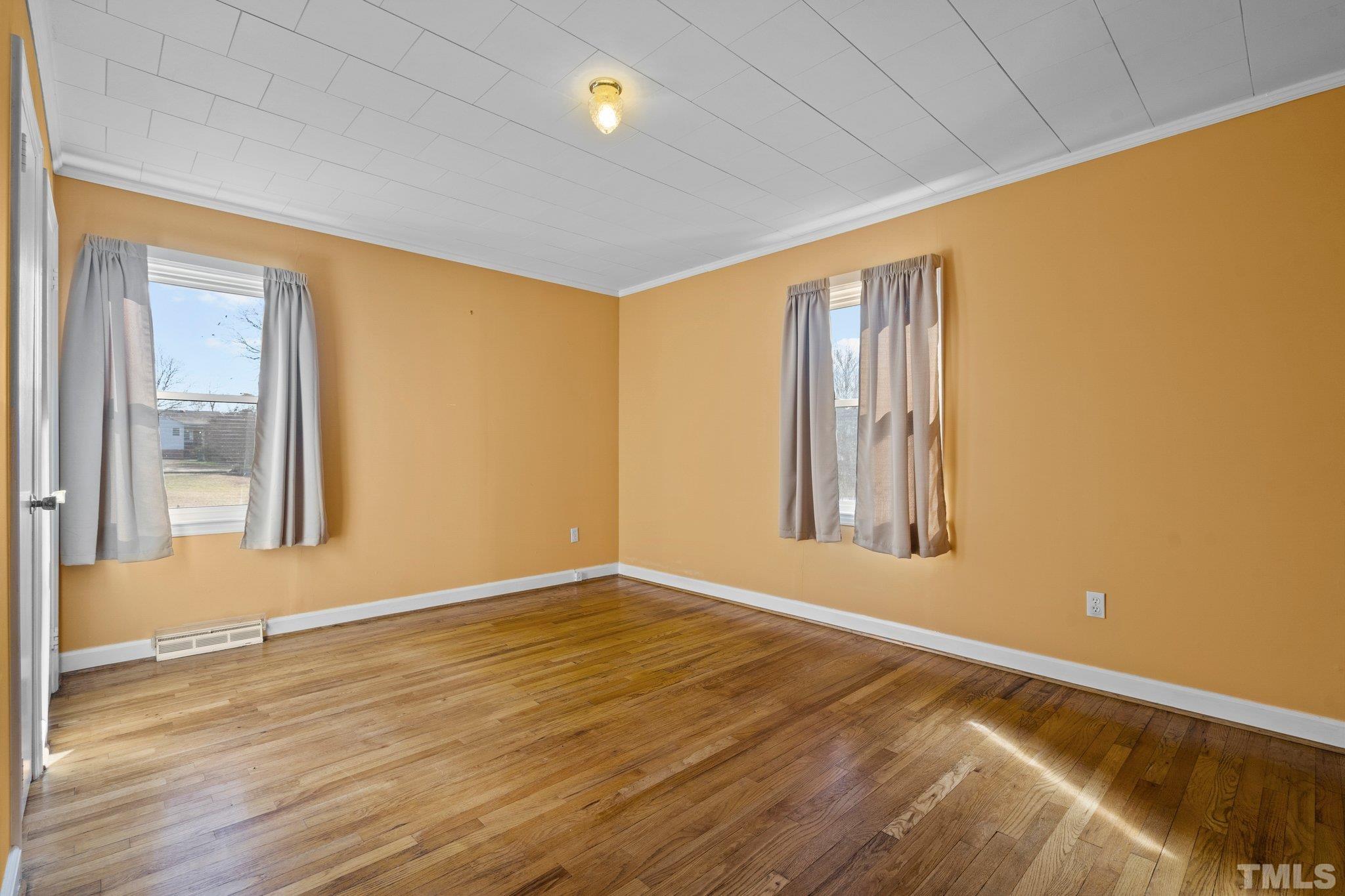 20 Dennys Store Road Roxboro, NC 27574 - Photo 14 of 46 a view of an empty room with wooden floor and a window