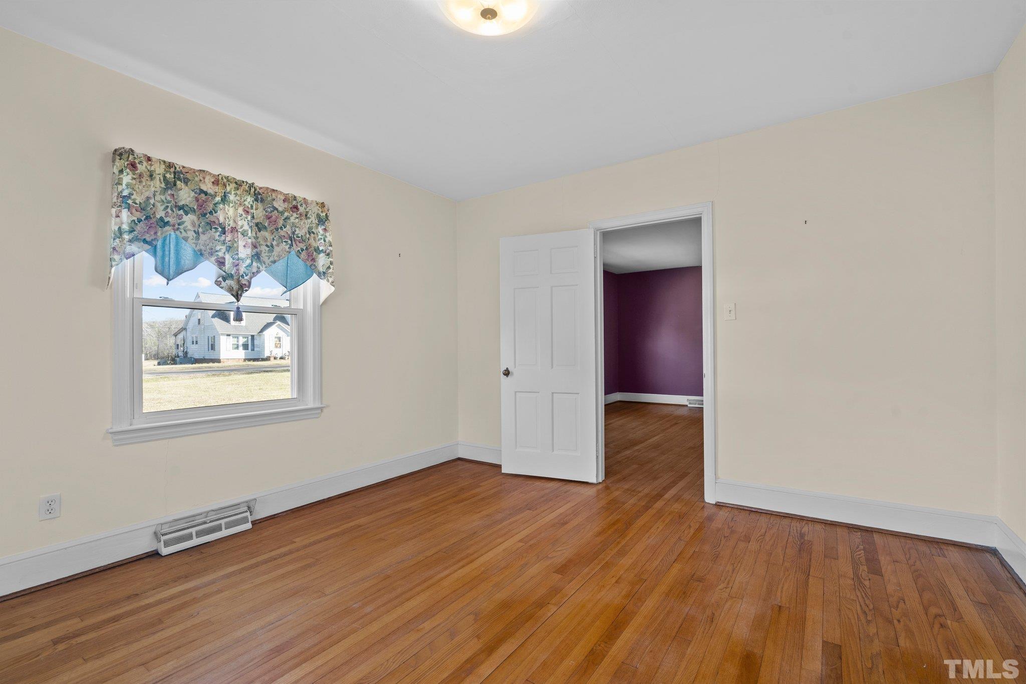 20 Dennys Store Road Roxboro, NC 27574 - Photo 28 of 46 an empty room with wooden floor and windows