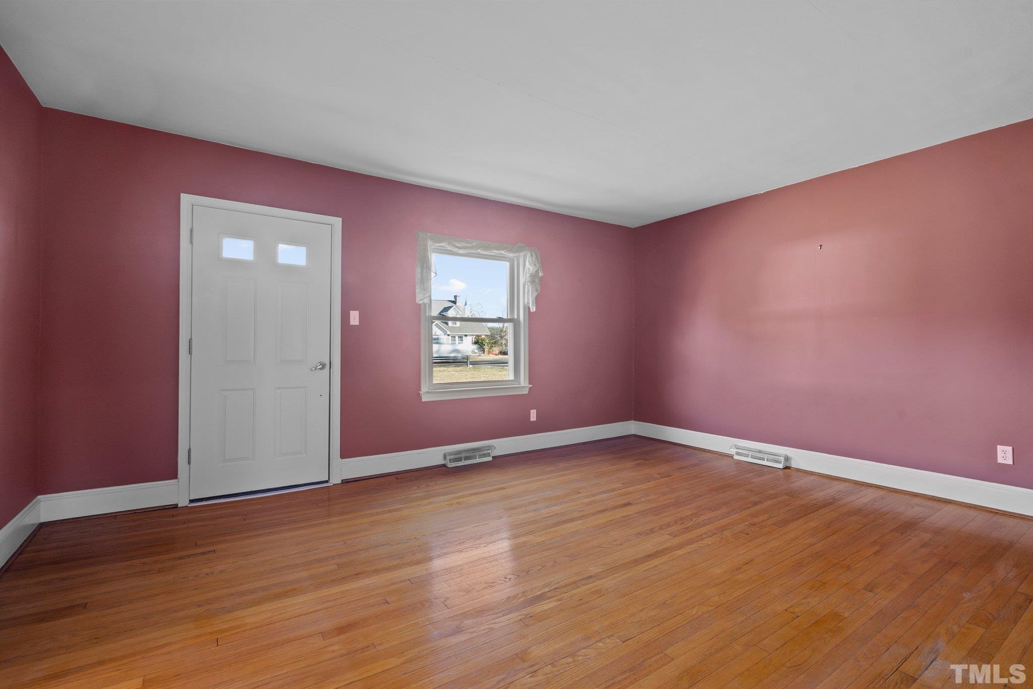 20 Dennys Store Road Roxboro, NC 27574 - Photo 29 of 46 an empty room with wooden floor and windows