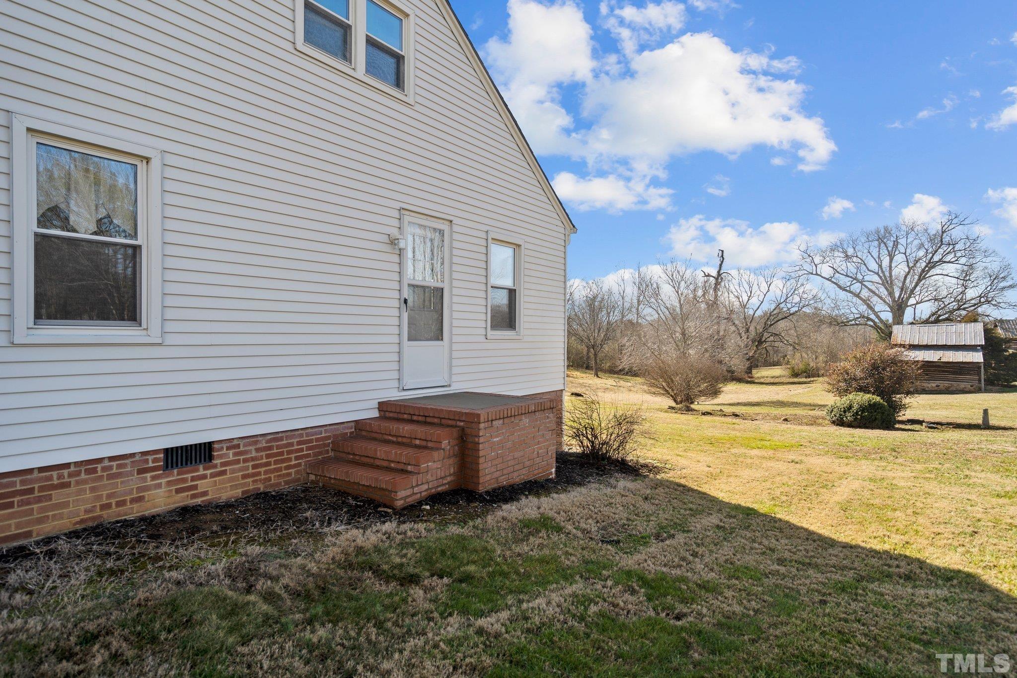 20 Dennys Store Road Roxboro, NC 27574 - Photo 6 of 46 a backyard of a house with yard and outdoor seating