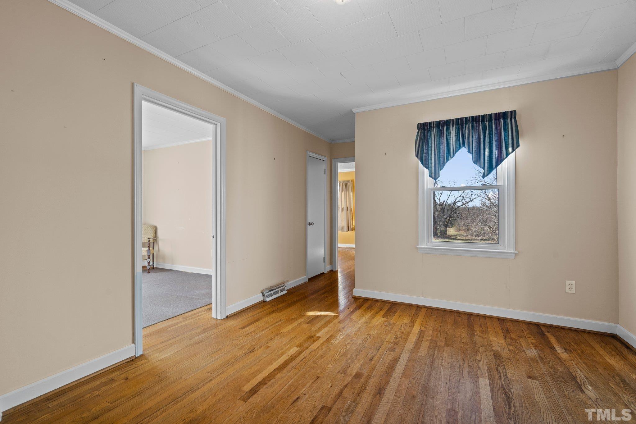 20 Dennys Store Road Roxboro, NC 27574 - Photo 8 of 46 an empty room with wooden floor and windows