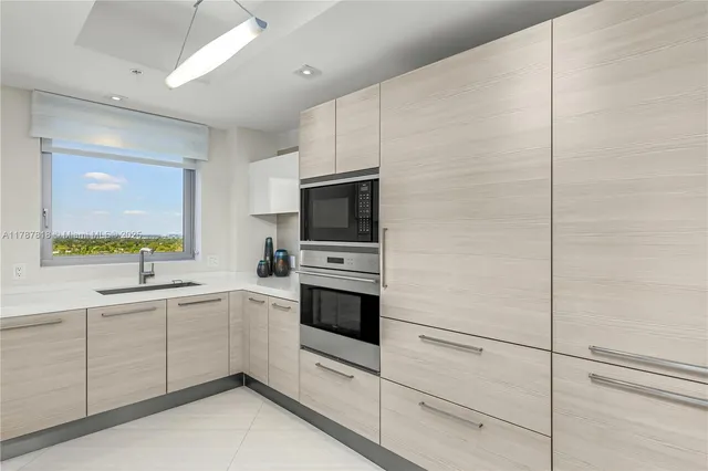a bedroom with a large bed and a large window