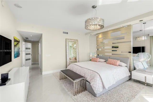 a large white bed in a white room