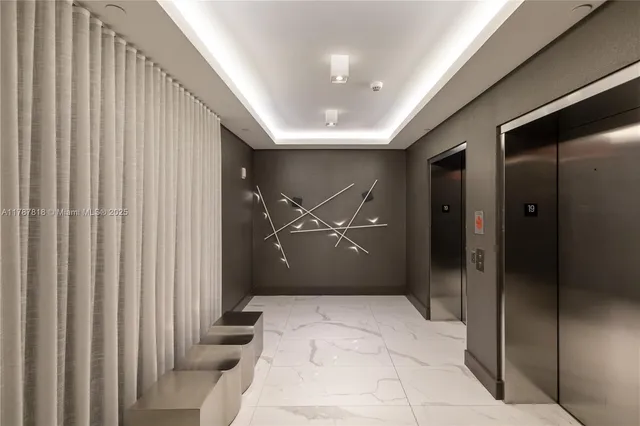 a living room with furniture large window and wooden floor