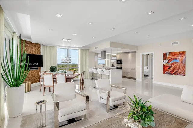 a large white kitchen with a large window and counter