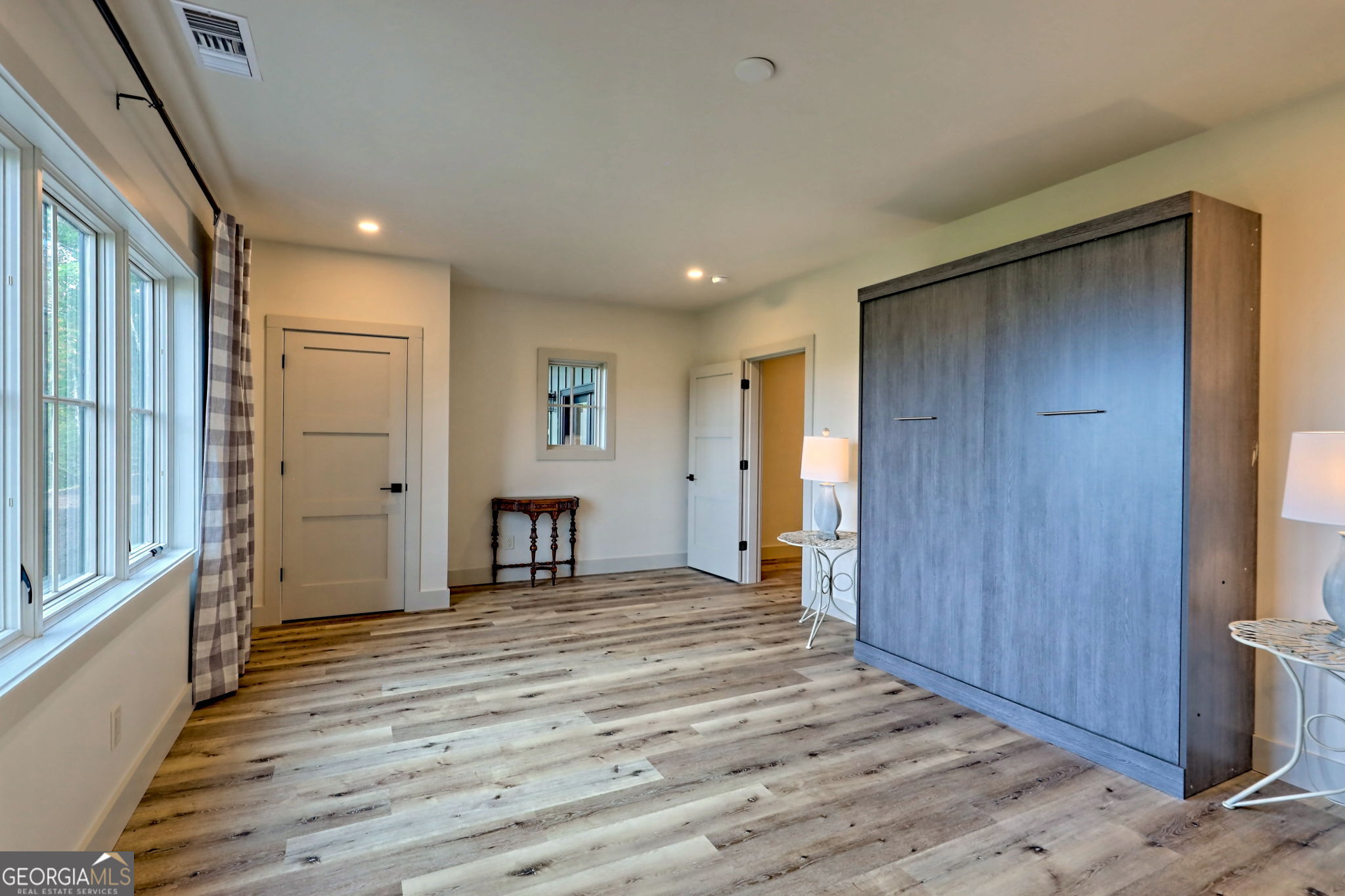 1095 Rabun Bluffs Drive Lakemont, GA 30552 - Photo 47 of 57 a view of an empty room with wooden floor and a window