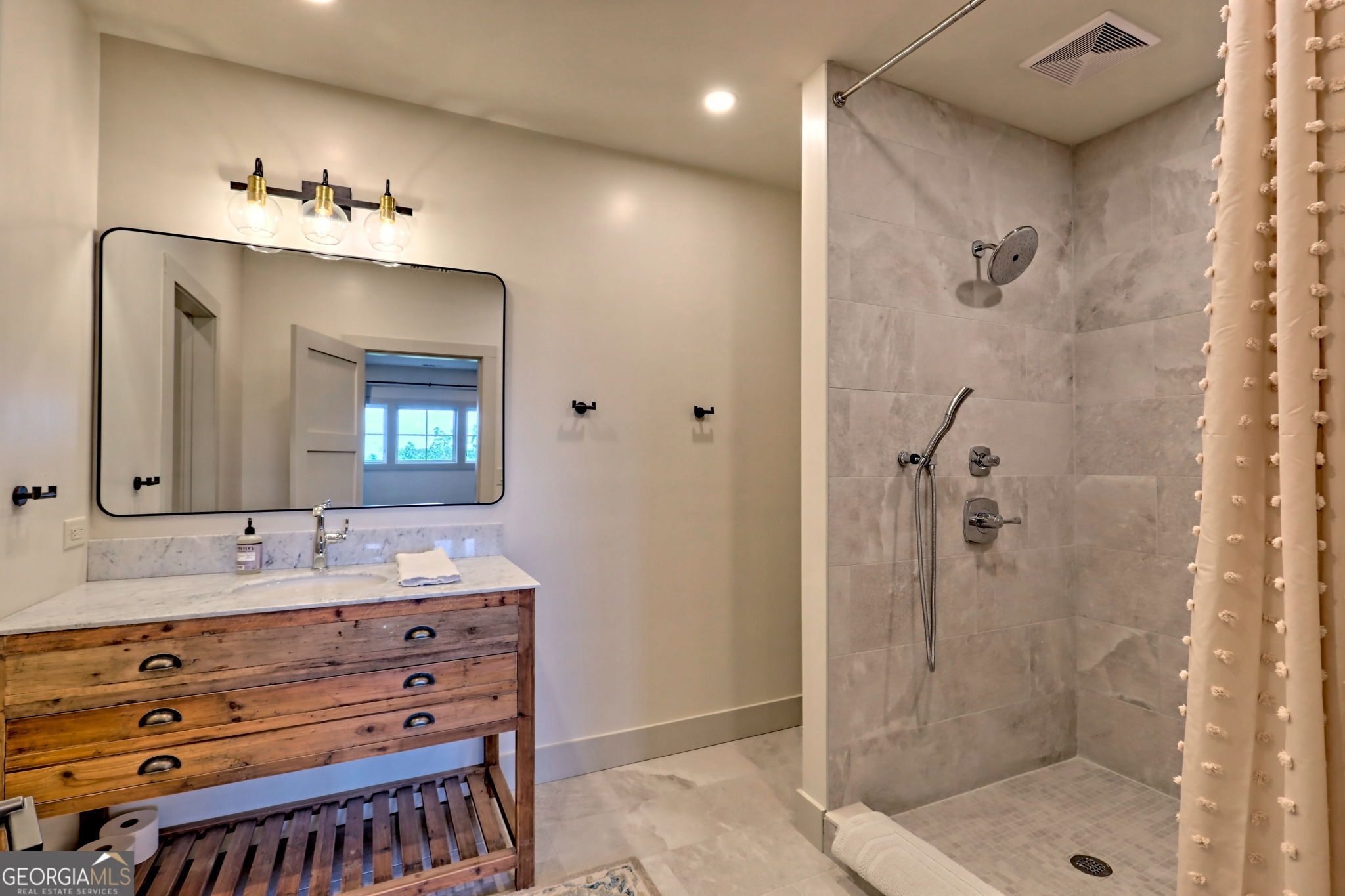 1095 Rabun Bluffs Drive Lakemont, GA 30552 - Photo 49 of 57 a bathroom with a double vanity sink mirror and shower