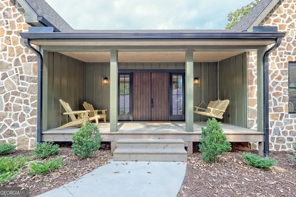 a front view of a house with potted plants