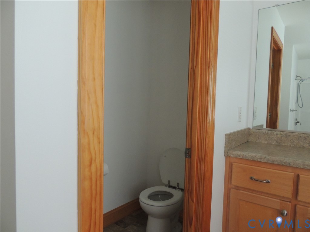 12512 Cox Road Church Road, VA 23833 - Photo 35 of 42 Bathroom with privacy comode and vanity with a lig