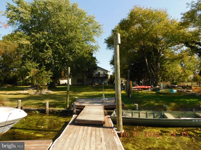 a backyard of a house with yard table and chairs