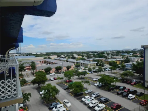 an aerial view of a house with balcony and trees all around