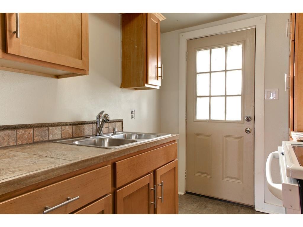 2103 Harrison Avenue Fort Worth, TX 76110 - Photo 11 of 19 a kitchen with a sink and cabinets