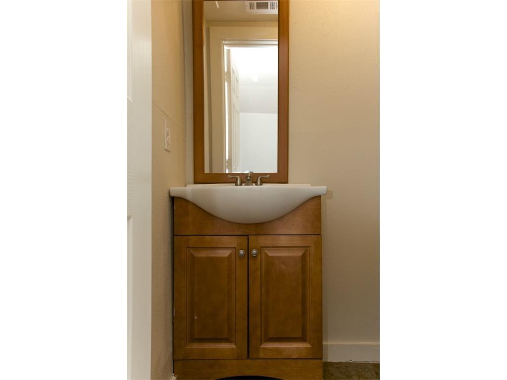 2103 Harrison Avenue Fort Worth, TX 76110 - Photo 13 of 19 a bathroom with a sink and a mirror