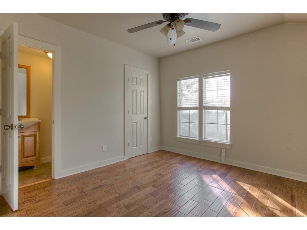 2103 Harrison Avenue Fort Worth, TX 76110 - Photo 14 of 19 a view of an empty room with wooden floor and a window