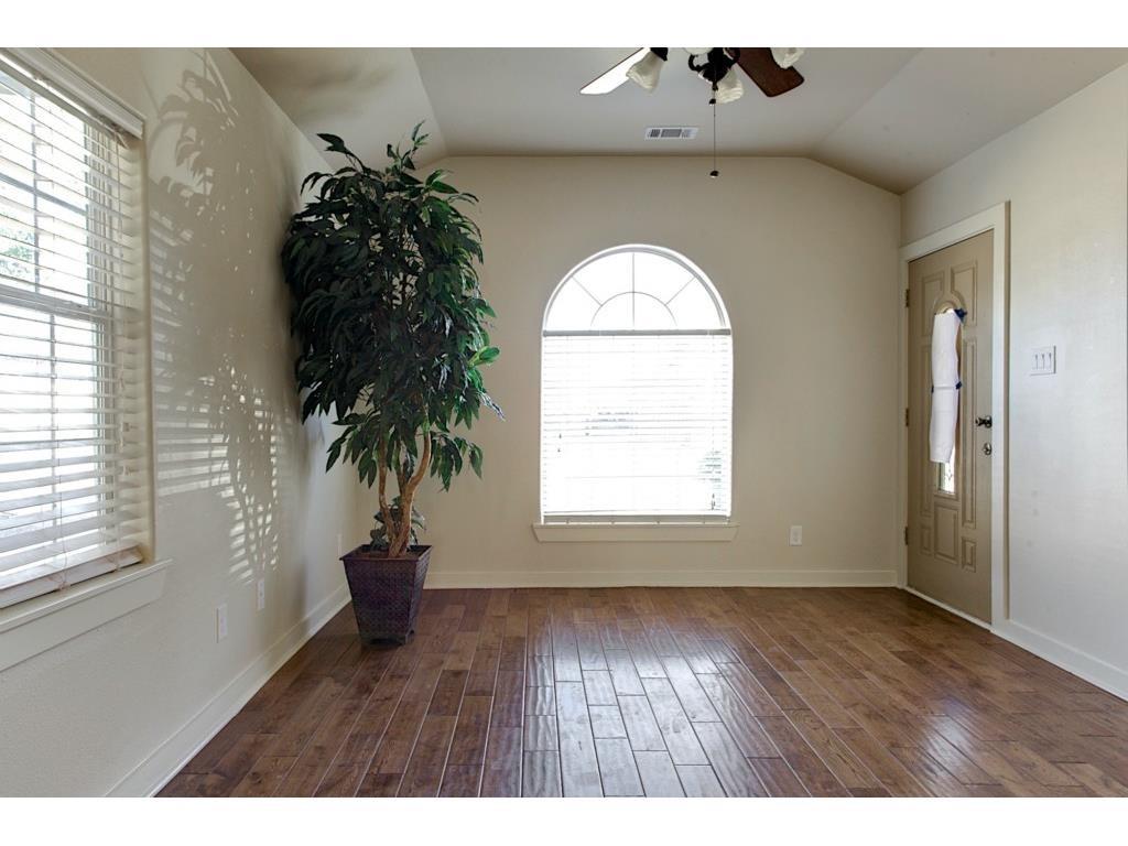 2103 Harrison Avenue Fort Worth, TX 76110 - Photo 4 of 19 an empty room with a potted plant and a large window