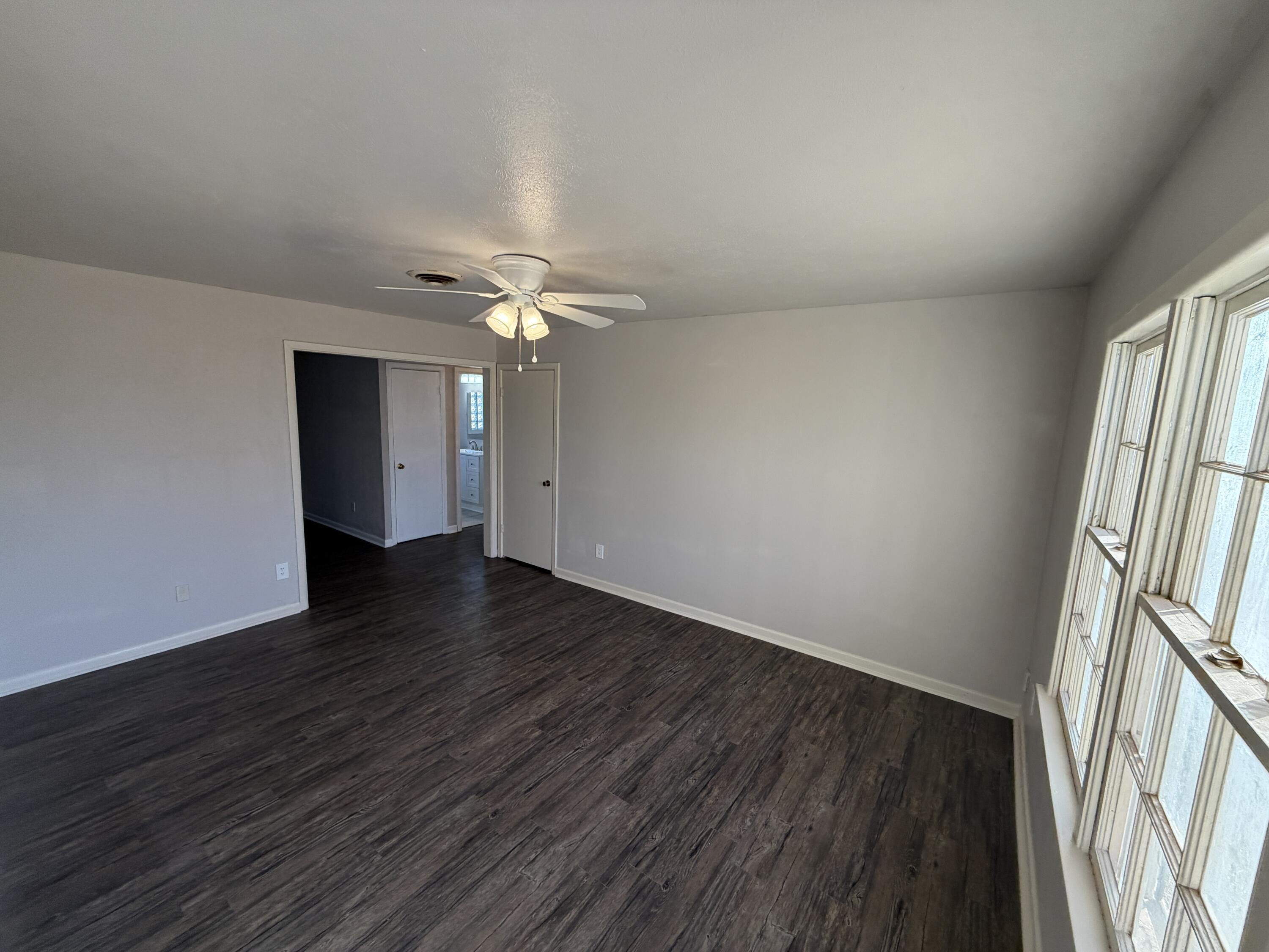 5114 46th Street Lubbock, TX 79414 - Photo 12 of 16 a view of an empty room with wooden floor and a window