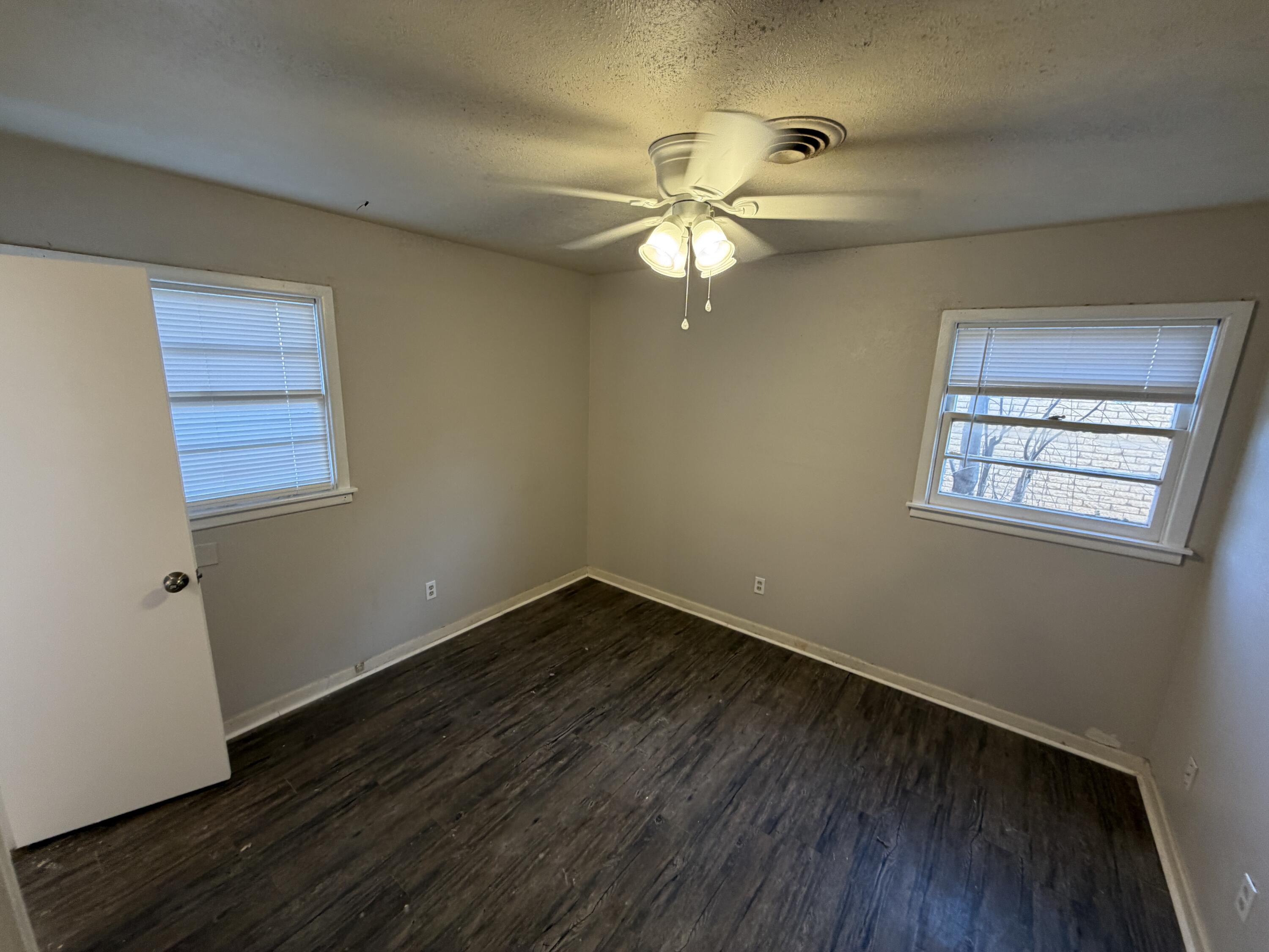 5114 46th Street Lubbock, TX 79414 - Photo 15 of 16 a view of a room with wooden floor and windows