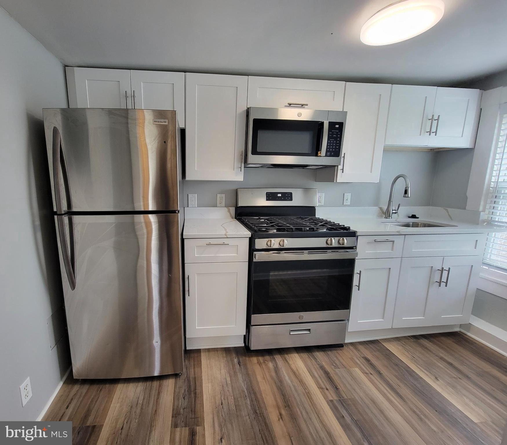 3414 Garrison Boulevard, Unit 3 Baltimore, MD 21215 - Photo 1 of 12 a kitchen with a refrigerator sink and microwave