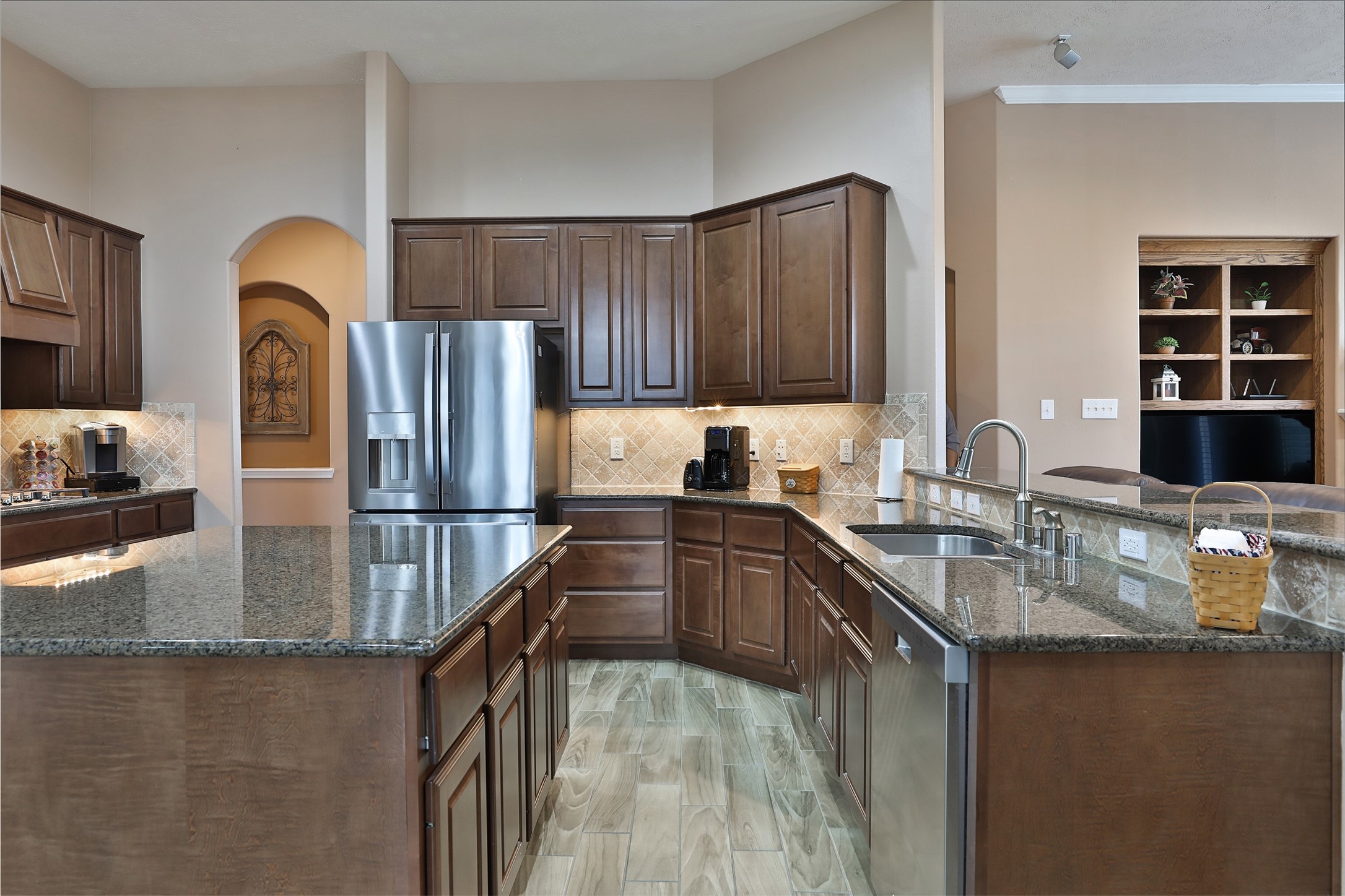 20519 Windrose Bend Drive Spring, TX 77379 - Photo 13 of 37 Whether your the one cooking or the one who keeps the cook company, this kitchen is for you! Featuring an abundance of cabinetry and counter space. Equipped with premium stainless-steel GE appliances, including upgraded double ovens and a spacious island, this kitchen serves as the true heart of the home.