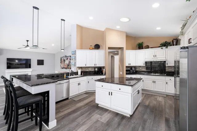 a bedroom with bed and a chandelier