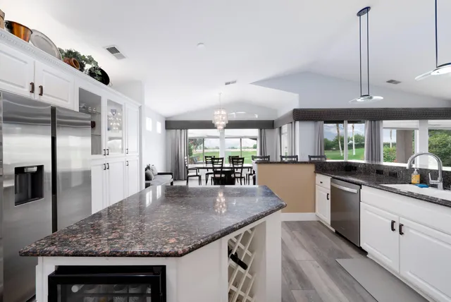 a bathroom with a granite countertop sink a mirror and a shower