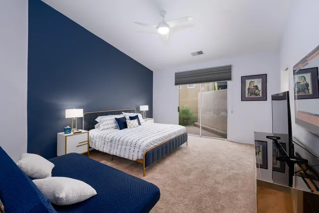 a bathroom with a granite countertop bathtub shower sink mirror and toilet