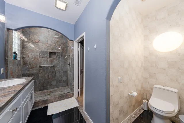 a bedroom with two bed and a window