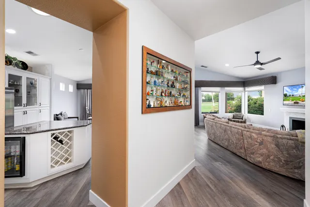 a living room with furniture and large windows