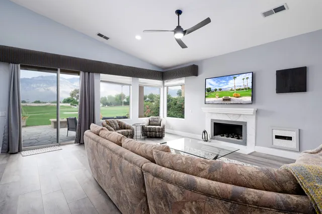 a living room with furniture or couch and a dining table