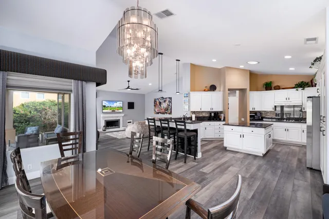 a kitchen with stainless steel appliances granite countertop a kitchen island a stove and a sink