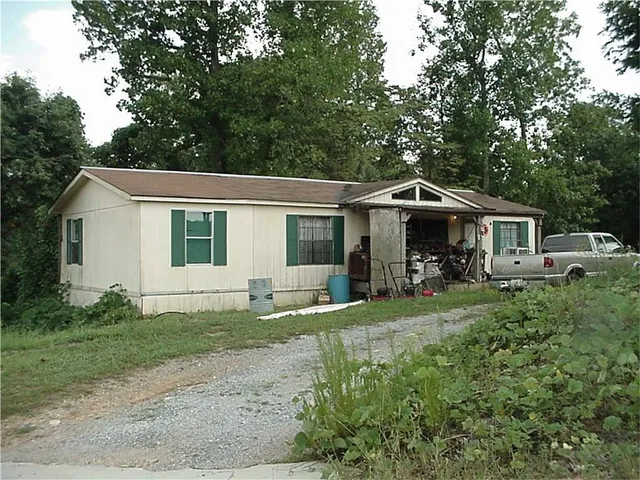 a front view of a house with a garden and porch
